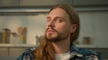 Serious pensive thoughtful thinking looking away to side Caucasian adult young millennial man male guy homeowner look at camera calm householder daydreaming ponder contemplate at couch home insurance