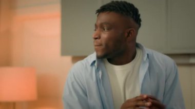 Happy active fooling funny smiling ethnic guy homeowner renter African American male man celebrate relocation moving day buying new apartment home dancing fun dance moving to music joy at kitchen