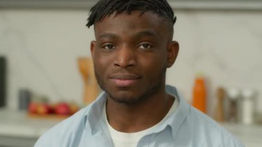 Happy portrait at home kitchen smiling toothy healthy teeth dental health man African American male guy homeowner renter looking at camera new house apartment rent tenant insurance loan food delivery