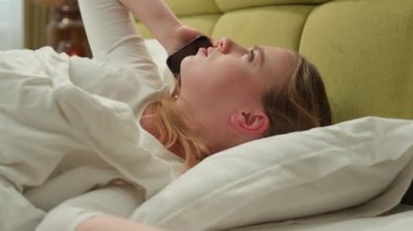 Morning bedroom home angry Caucasian woman girl lady wake up female stressed irritated furious worried talking mobile phone argue call conflict bad news hear problem lying in bed talk mad smartphone