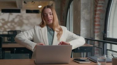 Smiling satisfied Caucasian businesswoman office manager girl female entrepreneur business woman finished computer work stretching hands sitting at workplace happy relaxed stress relief job well done