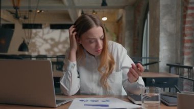 Business study work trouble in office confused puzzled Caucasian stressed tired student girl think difficulty task analyze stats data diagrams thinking businesswoman female business woman documents