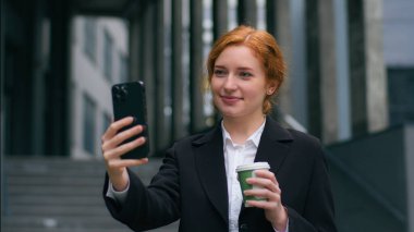 Başarılı bir şekilde gülümseyen Kafkas kızılı iş kadını bayan bayan bayan öğrenci öğrenci konuşmasına internet üzerinden mobil toplantı konferansını açık havada kahve molası vererek anlatın.