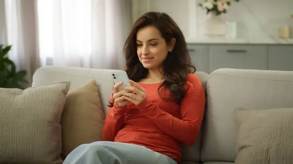 stock image Happy joyful glad Caucasian woman female playful girl buyer owner at home apartment couch sofa hold mobile phone chatting using online dating app watch video scrolling social media browsing internet