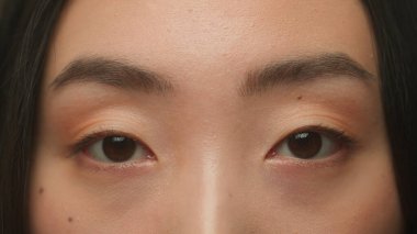 Makro yakın plan Asyalı kadın koyu renk gözler detaylarla yüzleşir Koreli Çinli kız göz merceği açık görüş açısı kirpikler cilt bakımı tıbbi cerrahisi güzellik sağlık
