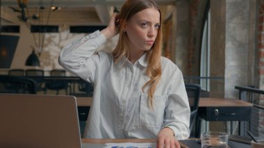 Business financial data work in office confused Caucasian girl analyze diagrams documents businesswoman female business woman scratching head thoughtful solving question problem uncertain hesitation