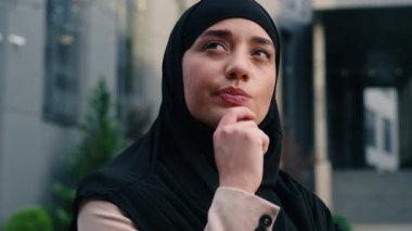 Müslüman kadın tesettüre girmiş Müslüman Arap iş kadını İslam kökenli iş kadını. Çözüm arayan, düşünceli, düşünceli, sorunlu, çözüme odaklanmış, kentte çene tutarak hayal kurmaya odaklanmış bir kadın.