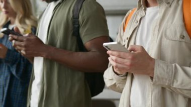Üniversite kolej akademisi dört öğrenci tanınamaz haldeki çok ırklı arkadaşlar erkek Kafkasyalı Afrikalı Amerikalı erkek kadın kız cep telefonu bağımlısı cihazlar video oyunu bağımlısı
