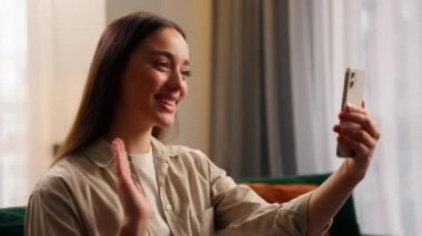 Kafkasyalı kadın bayan bayan etkili blogger video blogger konuşan cep telefonu görüntülü konuşma konferans sanal toplantı görevi merhaba gülümseyen vlog blog kanalı sosyal medya evde