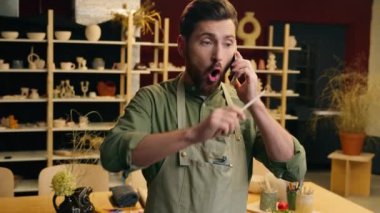 Kızgın kızgın Kafkasyalı iş adamı erkek işadamı iş adamı çömlekçi sanatçı öfkeli cep telefonu çağrısı bağırıyor çatışma çığlıkları atıyor kapalı mekanda cep telefonu satışı sorunları tartışılıyor