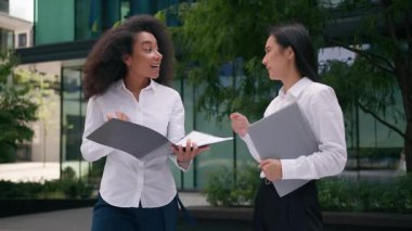 Çok kültürlü Asya kökenli Afrikalı Afrikalı Amerikalı kadınlar anlaşmazlığı tartışıyorlar. Anlaşmadaki anlaşmazlıkları tartışıyorlar. Anlaşma ortakları iş kadınları iş kadınları iş şehirlerini dışarıda görüşüyor.