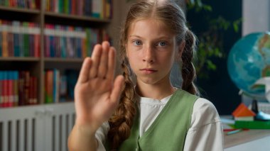 Ciddi şekilde üzgün, hayal kırıklığına uğramış, küçük beyaz kız çocuk, liseli kız öğrenci, kameraya bakan öğrenci, avuç içi göstergesi, el hareketi, titreyen baş hareketi, kapalı alanda uyarı yok.