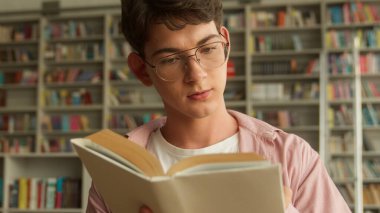 Genç adam, lisede, kitapçıda kitap okumakla ilgilenen ve beyaz erkek erkek öğrenci eğitimi alan üniversite kütüphanesinde edebiyat okumak isteyen sınavlara hazırlanıyordu.