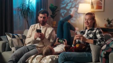 Aile akşam kanepede birlikte kanepede otururken cep telefonu bağımlılığı aletleri kullanarak video oyunu oynayarak sosyal medyada kayan aşırı kullanışlı ebeveynleri görmezden gelerek anne, küçük çocuk kız evlat