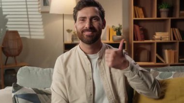 Kafkas erkek portresi, evde günlük oturma odasında gülümseyen, mutlu, ev sahibi, serbest çalışan, kameraya bakan iş adamı.