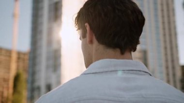 Yakından bakıldığında, tanınmayan, tanınmayan beyaz bir adam. Etrafa bakınıyor. Binaların iş adamı, iş adamı, kendine güvenen başarılı bir erkek, şehir girişimcisi.