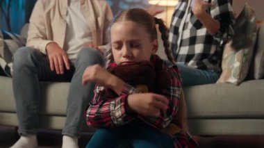 Üzgün çocuk kız çocuğu üzgün üzgün üzgün oyuncak oyuncak ayı kulakları kapalı, stresli tartışmaları görmezden gel anne baba ve ev erkeği kadın şiddeti tartışmaları aile içi şiddet