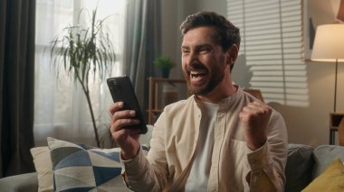 Kafkas mutlu kazananı heyecanlı iş adamı duygusal ev sahibi erkek şampiyon online kumar cep telefonu mesajı iyi şans akıllı telefon zaferi çığlığı evde kutlayın