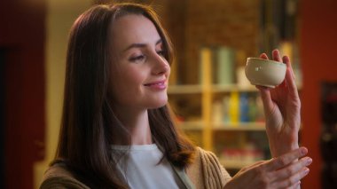 Çömlek tasarımcısı kadın heykeltıraş Kafkas kadın gülümseyen esnaf tezgah atölyesi sahibi el yapımı fincan kil seramik sanat modelleme el işi çanak çömlek yapıyor.