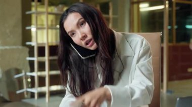 Stressed busy Asian business woman multitasking businesswoman Chinese girl stress deadline in office call mobile phone difficult tasks laptop online working hurry Korean Japanese female worker arguing