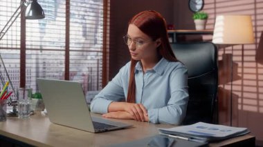 Kafkasyalı iş kadını dizüstü bilgisayara bakıyor. Ofis çalışanı bayan iş kadını. İş yeri video konferansında iş kadını şirketinde çalışıyor.