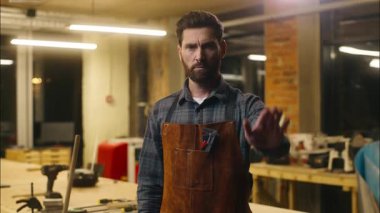 Kafkasyalı ahşap ustası atölye atölyesinde atık hareketi gösteriyor. Marangoz, reddedilen mimar, zanaatkar, dur tabelası tamircisi. Savunma aralarındaki mesafeyi koru sembolünü göster.