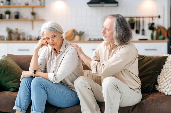 Sad Caucasian Mature Spouses Sit Couch Living Room Husband Reassures — Stock Photo, Image
