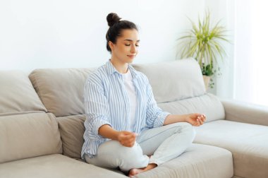 Sabahları dinleniyorum. Sakin, hoş, genç bir Arap ya da Hintli kadın rahat bir oturma odasında, kanepede oturuyor ve gözleri kapalı bir nilüfer pozisyonunda meditasyon yapıyor, yoga farkındalığı eğitimi yapıyor.