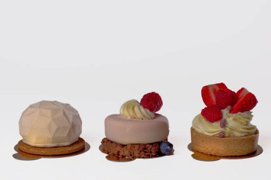 three powder cake with sharp edges on a wooden substrate on a white background. Isolated.