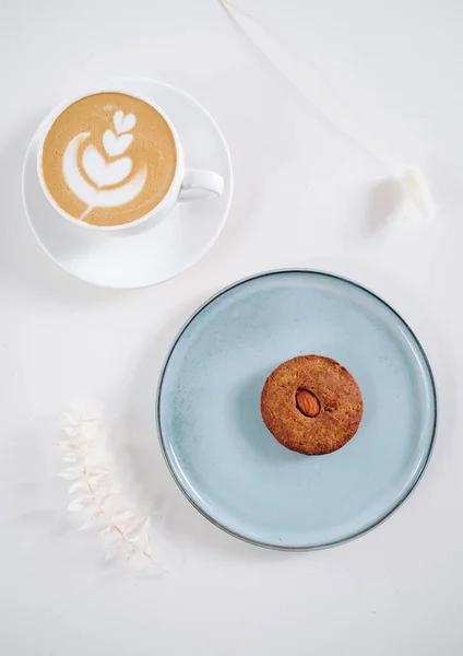 Cookies with nuts inside and coffee with a pattern
