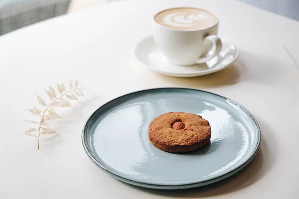 Cookies with nuts inside and coffee with a pattern
