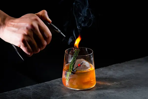 aromatic cocktail with a sprig of pine needles and round ice