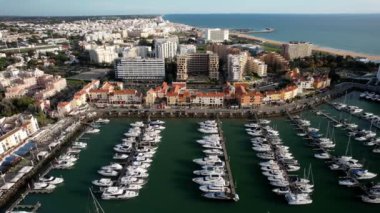 Vilamoura, Algarve, Portekiz - 20 Kasım 2022: Vilamoura marinasının güzel hava perspektifi. Lüks şehirler, limana yanaşmış yatlar. Portekiz 'in güneyindeki Algarve' de ünlü bir seyahat merkezi.