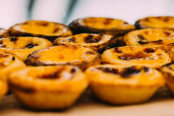 stock image Stack of Portuguese egg tart also known as Pasteis de Nata on display in front of shop - selective focus