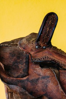 Worn leather western style horse saddle.
