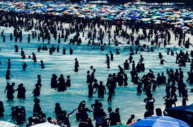 Rio de Janeiro, Brazil - January 15, 2023: Crowd of people at Leme and Copacabana beach on a hot summer day, Rio de Janeiro, Brazil