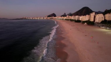 Aerial drone view over Copacabana Beach in Rio de Janeiro, Brazil with iconic Carioca mountainous landscape visible