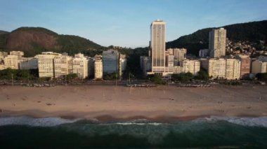 Aerial drone view approaching Avenida Atlantica and Avenida Princesa Isabel in Copacabana, Rio de Janeiro, Brazil at dusk