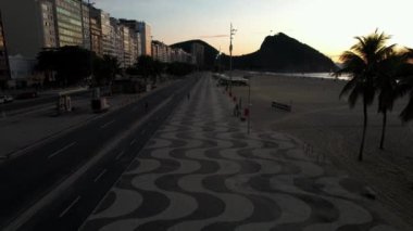 Aerial view of famous Copacabana Beach boardwalk with its way mosaic in Rio de Janeiro, Brazil at dusk