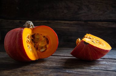 Cut pumpkin on a wooden table. Cooking in the kitchen.