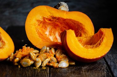 Sliced pumpkin in a white bowl on a wooden table.