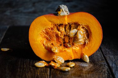 Sliced pumpkin in a white bowl on a wooden table.