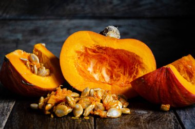 Sliced pumpkin in a white bowl on a wooden table.