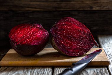 Kesme tahtasında pancar kökü ve koyu bir arka plan. Mutfakta ev yemeği..