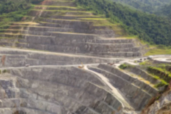 Blurred background of open pit mining. Aerial view of industrial slope on mineral mine site.