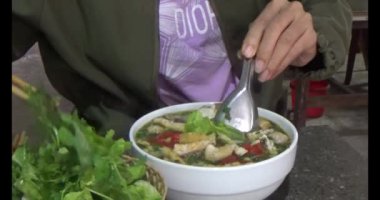 Bir restoranda pho yemek. Pho Vietnam 'da özel bir yemektir.