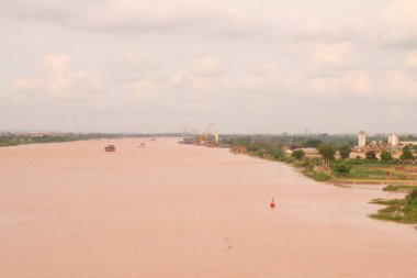 Nehir Vietnam 'da. Nehirde kayıklar ve gemiler, kıyılarda kırsal köyler, balık kafesleri, sebze tarlaları var.