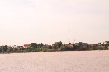 Nehir Vietnam 'da. Nehirde kayıklar ve gemiler, kıyılarda kırsal köyler, balık kafesleri, sebze tarlaları var.