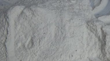 Çiftçinin eli un temizlemek için sepeti kullanıyor.