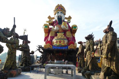 NAKHON PATHOM, THAILAND - JANUARY 31:Big 14 meter tall Cai Shen (also known as the Chinese God of Wealth, God of fortune) statue Buddha at Wat Huai Plu on January 31, 2023 in Nakhon Pathom, Thailand clipart